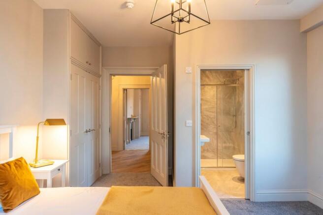 Bright, freshly decorated master bedroom with a...