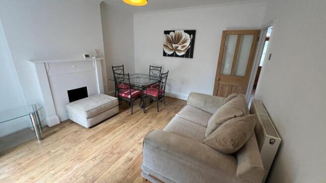 Spacious living area with modern dining set...