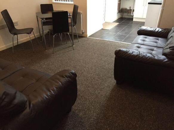 Spacious lounge with comfy sofas and dining are...