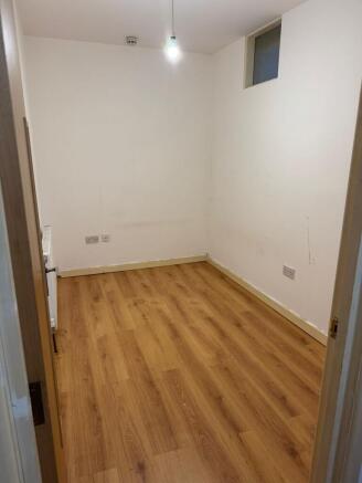 Bright bedroom with stylish wood laminate floor...