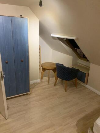 Charming loft room with ample storage space...