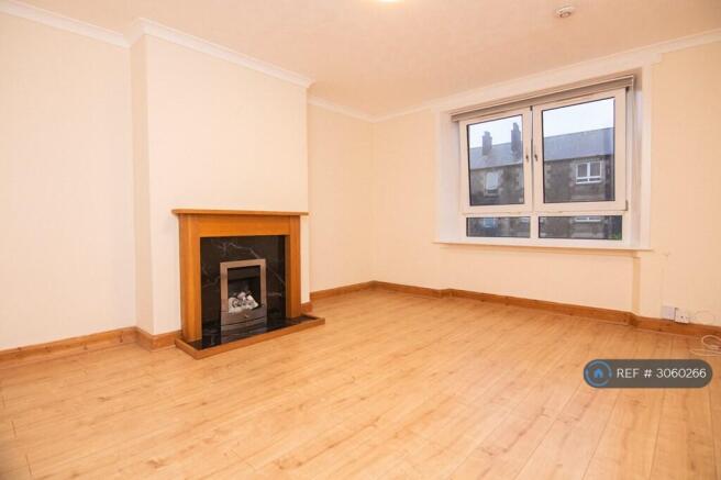 Lounge With Large Window And Fireplace Surround