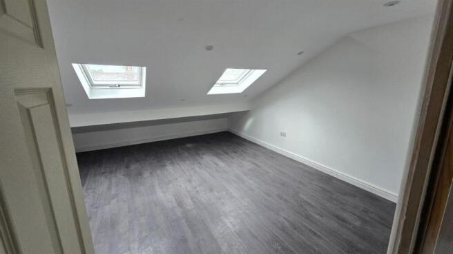 Spacious loft bedroom with bright skylights...