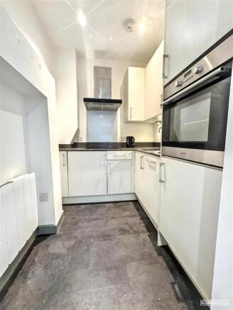 Bright modern kitchen with integrated appliance...
