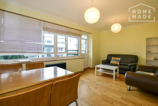 Bright furnished living room with dining area...