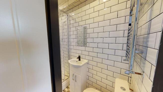 A modern, clean bathroom with white subway tile...