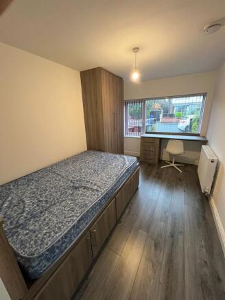 Neat single bedroom with built-in under-bed sto...