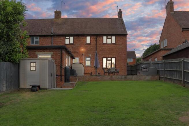 Rear view of the property at dusk