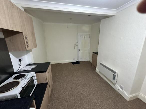 Versatile living area with open kitchenette....