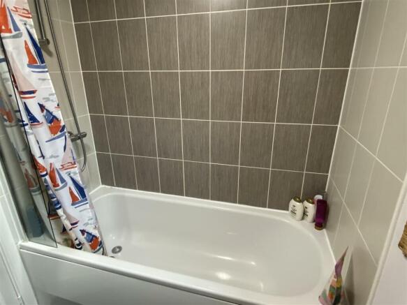 Family bathroom with shower over
