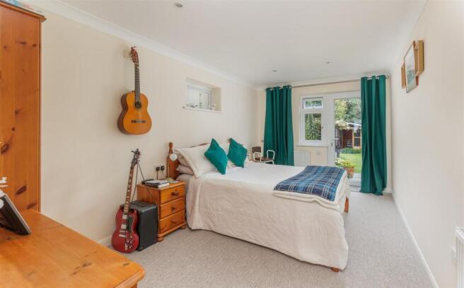 Spacious bedroom with doors to garden