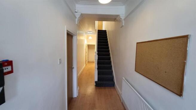 Bright, clean hallway with wood-look flooring...
