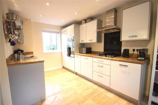 Bright and modern kitchen featuring clean white...
