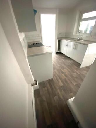 Bright modern kitchen with stylish wood floorin...