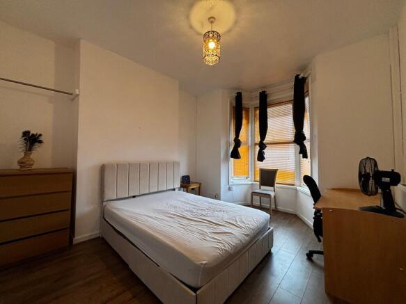 Bright and spacious bedroom with study desk are...