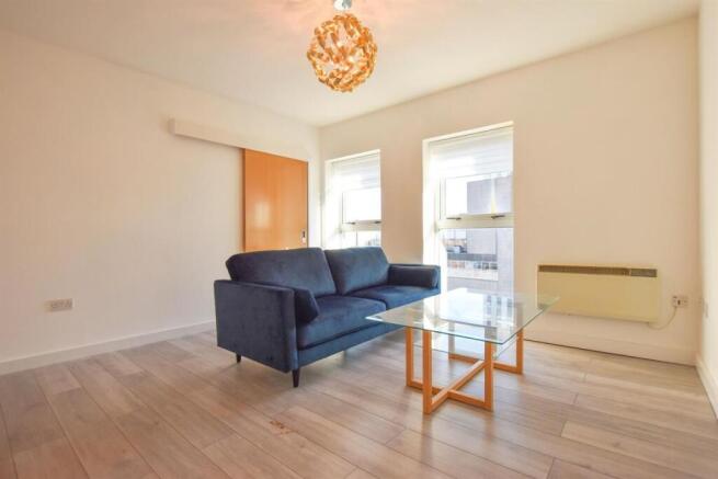 Bright and modern living room with plush seatin...