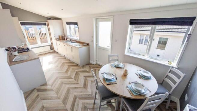 Dining Area With Modern Kitchen And Large Windows