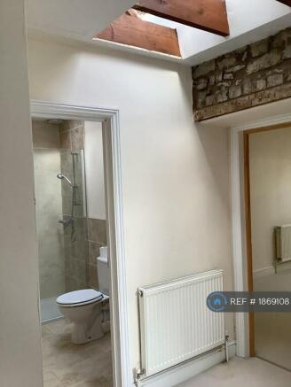 Landing With Exposed Stone Walls And Beams