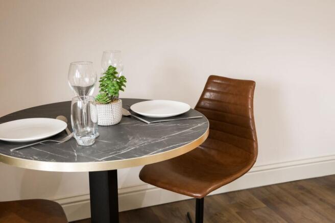 Stylish small dining setup with leather chair...