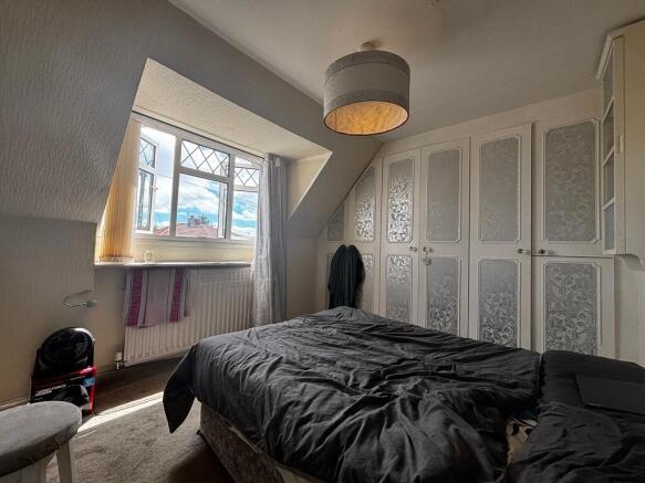 Bright bedroom with extensive fitted storage...