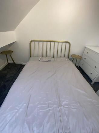 A cozy and inviting double bedroom featuring a ...