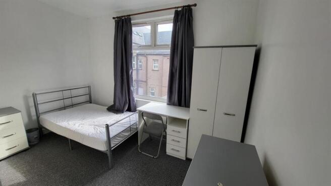 Bright, simply furnished double bedroom with a ...