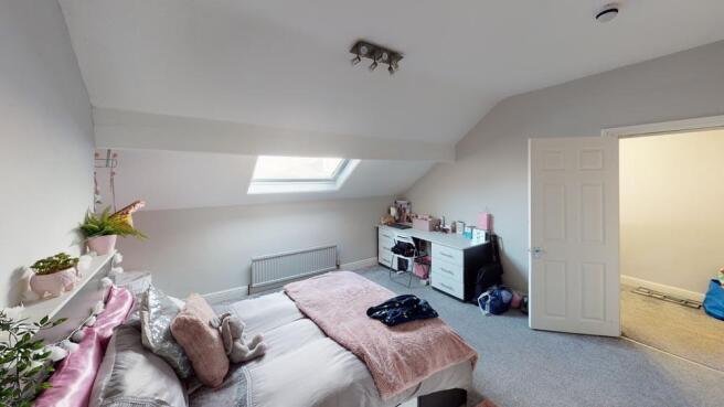 A cozy bedroom with a large bed, soft pillows, ...