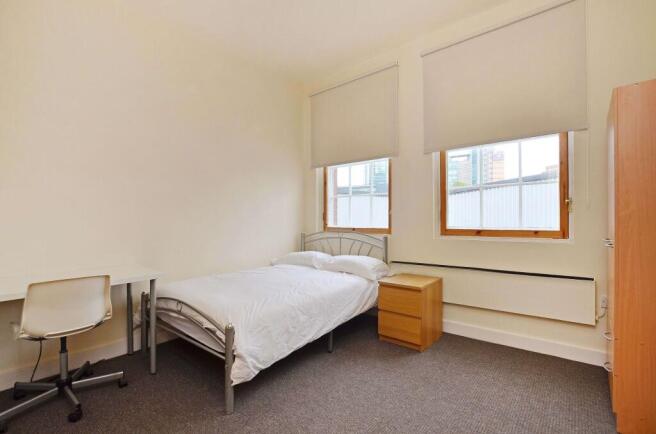 A bright, tidy single bedroom featuring a singl...