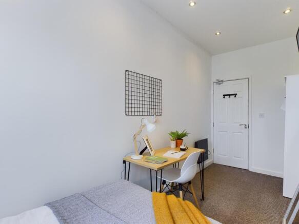 A bright and inviting double bedroom featuring ...