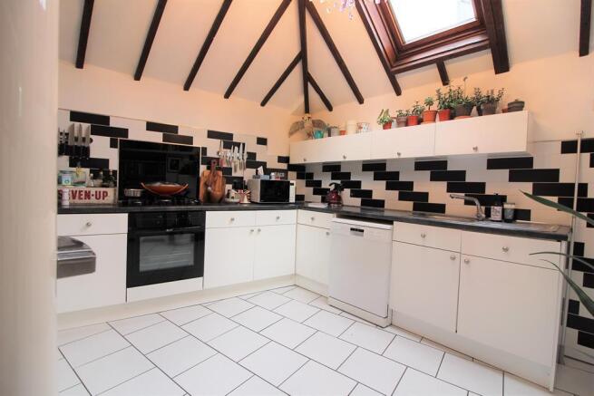 FITTED KITCHEN WITH VAULTED CEILING