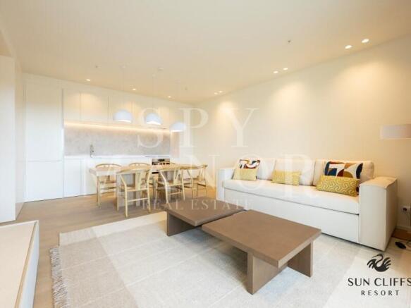 Bright modern living room at Sun Cliffs Resort in Lagos Algarve, featuring an elegant sofa, dining area, and luxury finishes.