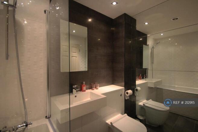 Full Tiled Bathroom With Shower And Bath