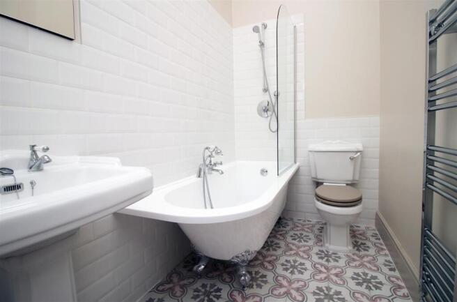 Elegant bathroom with a stylish roll-top bath...