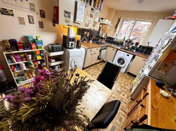 Warm, well-equipped kitchen with wooden worktop...