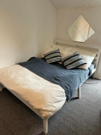 A spacious and well-maintained bedroom featurin...