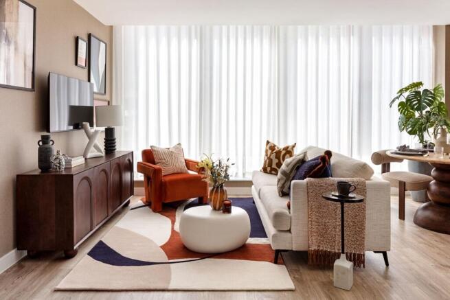 Floor to ceiling windows flood the open plan living area with natural light