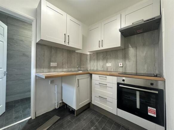 Modern kitchen with integrated oven and worktop...