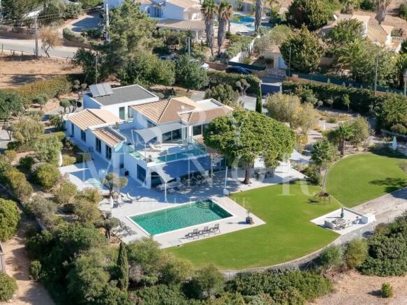 Drone view of a luxury villa in Caramujeira with swimming pool and private garden.
