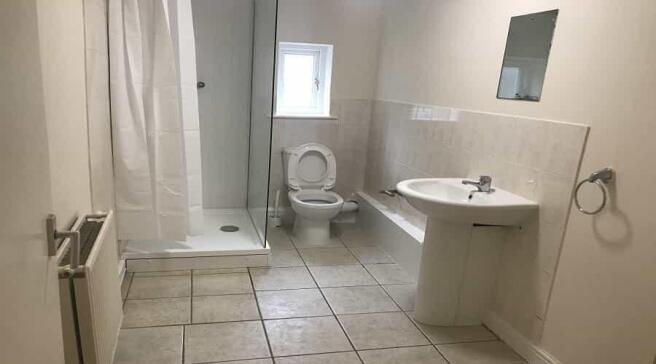 A clean and well-maintained bathroom with a sho...