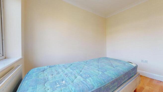 Bright bedroom with neutral decor and natural l...