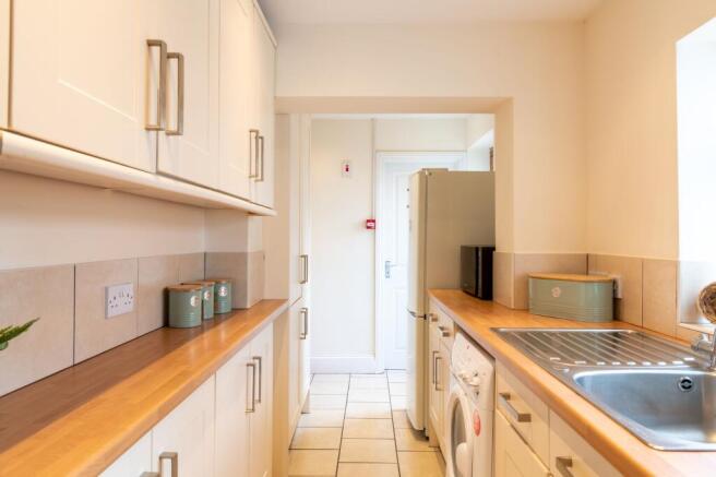 Bright, modern galley kitchen with wood-effect ...