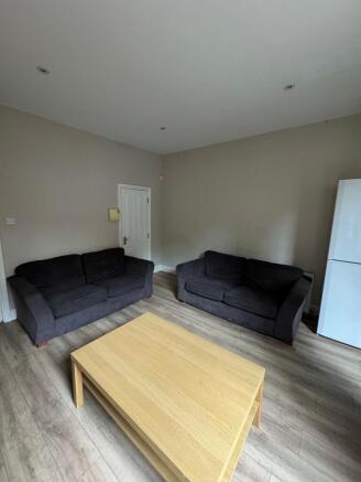 Bright, neutral living room with matching dark ...
