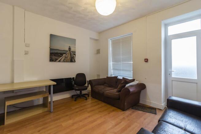 Bright living area with plush sofa and desk...