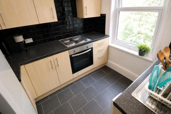 Modern kitchen with sleek black tiling....