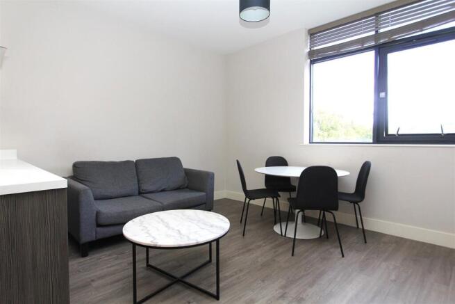 Modern living area with stylish dining set...