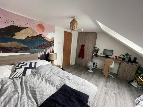 A bright and airy bedroom featuring a large bed...