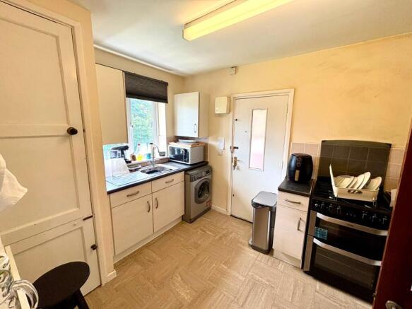 Bright kitchen with modern appliances and stora...