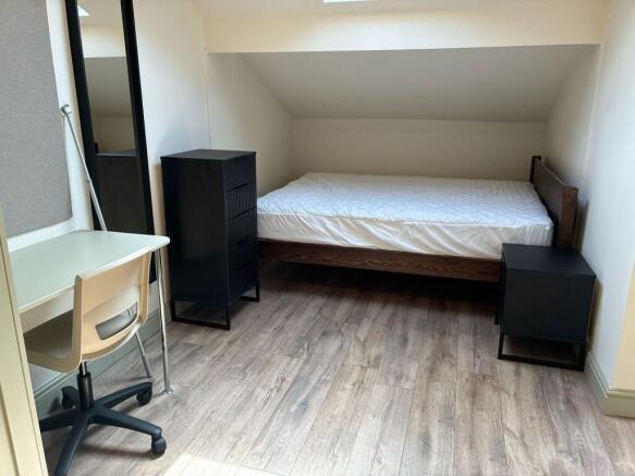 Modern attic room with desk and sleek furniture...