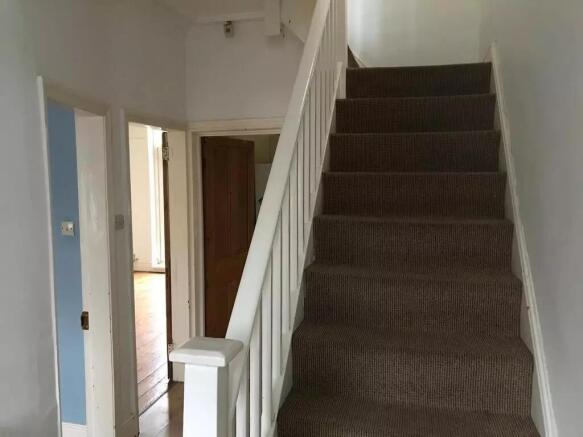 A clean and well-maintained hallway with white ...