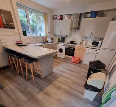 Bright kitchen with breakfast bar and appliance...